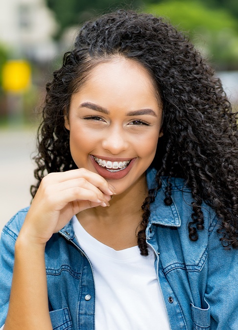 Young woman with classic braces smiling