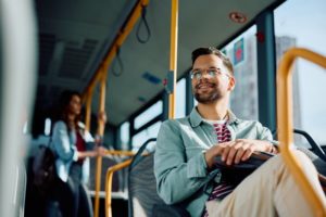 a man sitting on a bus and smiling